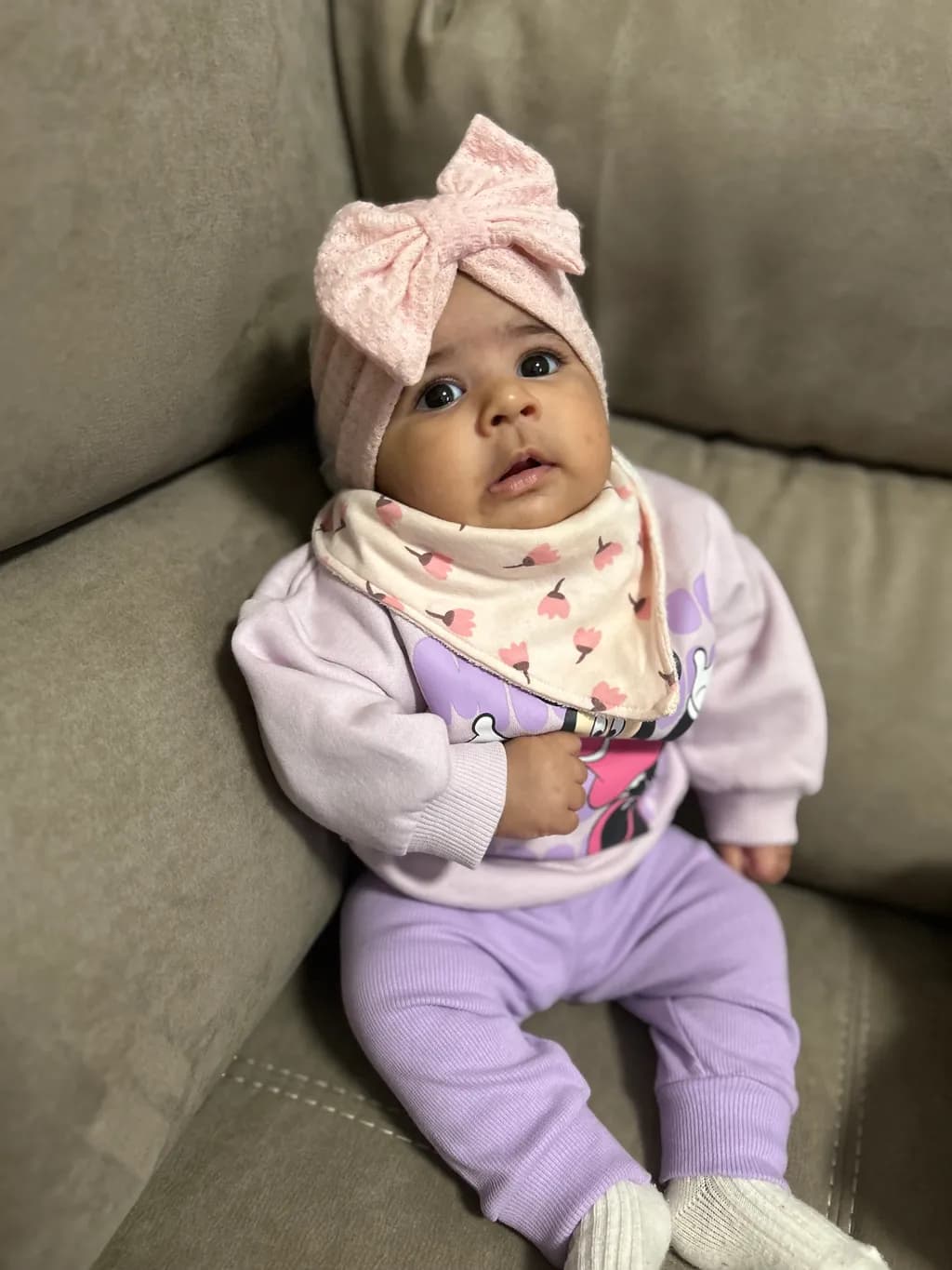 Adorable Moments: A Sweet Baby in Cozy Pastels with a Playful Bow