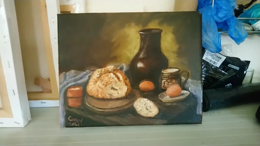 Rustic Still Life: A Warm Embrace of Bread, Eggs, and Earthenware