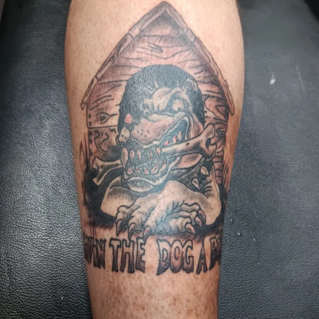 Fierce Guardian: The Aggressive Dog Tattoo with Bone and Attitude