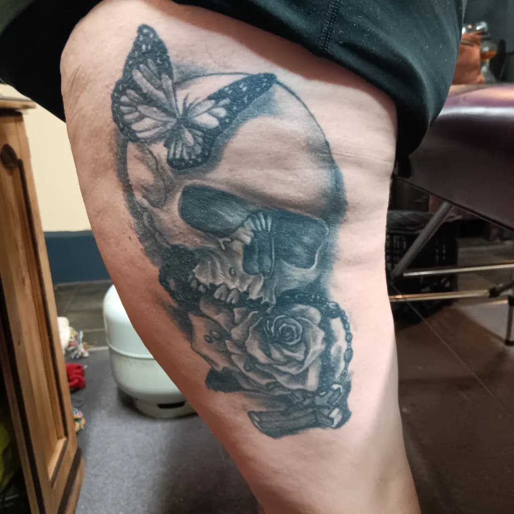 Eternal Beauty: A Skull, Butterfly, and Rose Tattoo Masterpiece