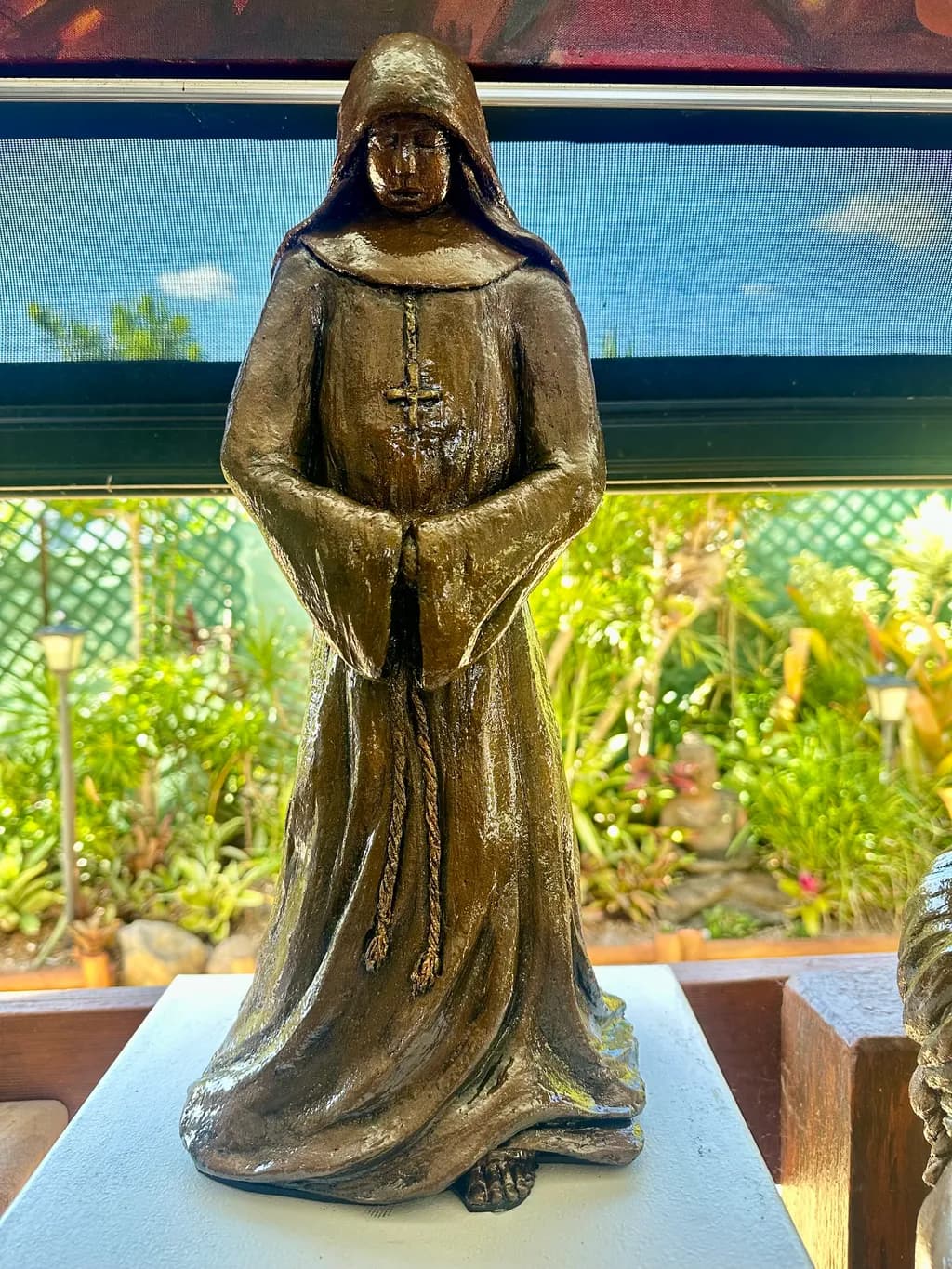 Serenity in Silence: A Bronze Cloaked Figure of Contemplation