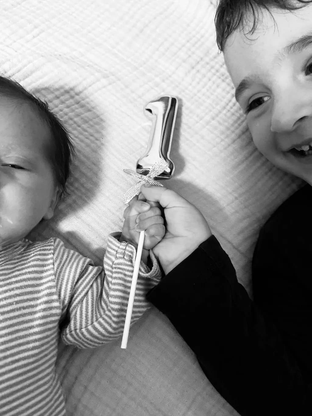 Joyful Siblings: A Black and White Celebration of First Moments