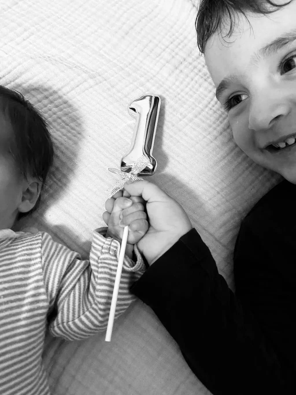 Celebrating First Moments: A Sibling's Joyful Embrace on a Special Day