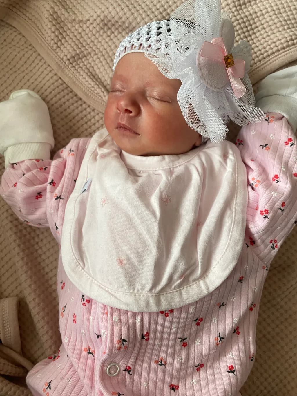Dreamy Innocence: A Serene Portrait of a Sleeping Baby in Floral Pink Attire