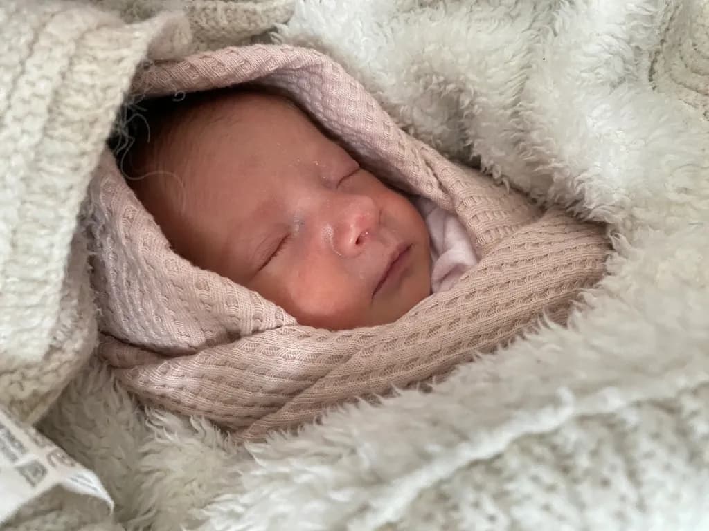Cozy Innocence: A Peaceful Baby Wrapped in Soft Embrace