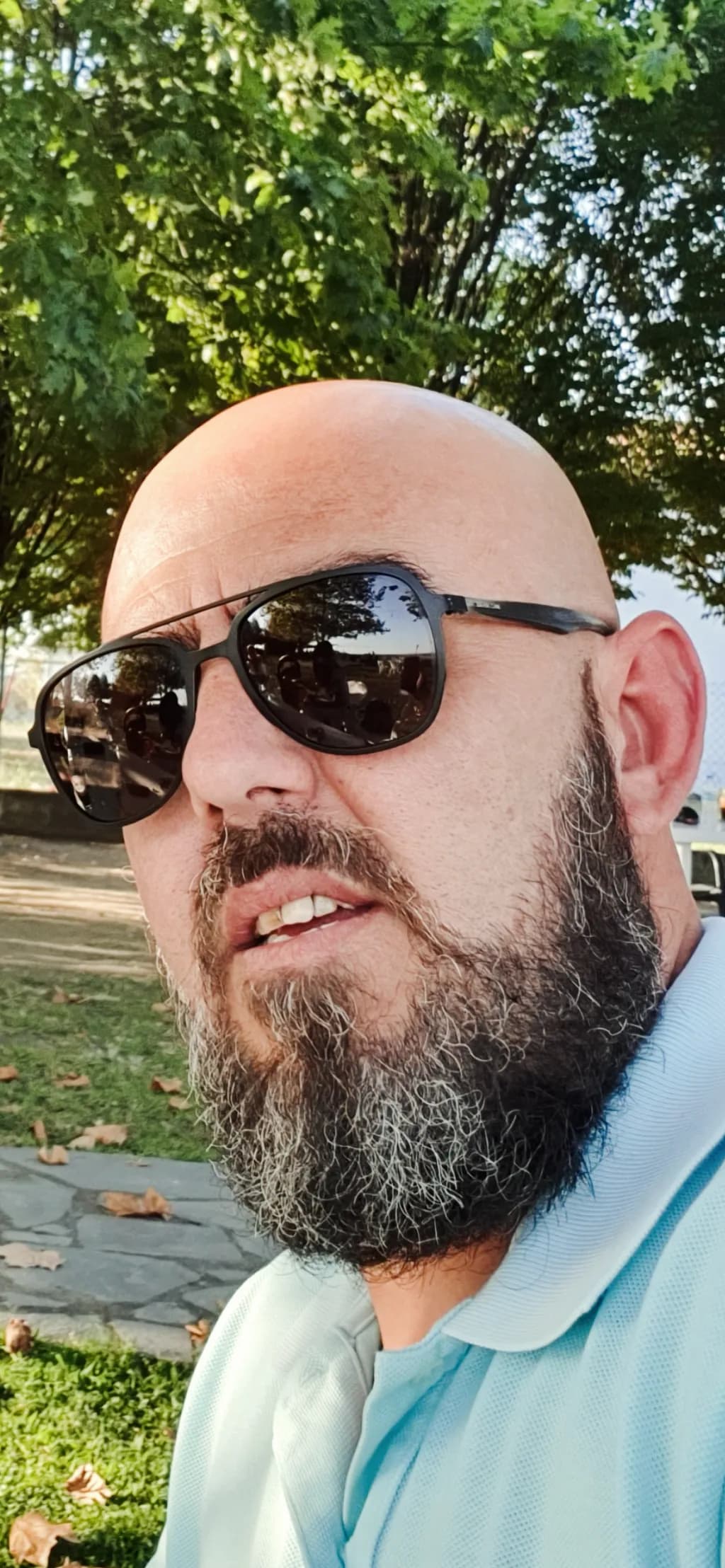Chasing Sunlight: A Casual Portrait of a Bearded Man in Nature's Embrace