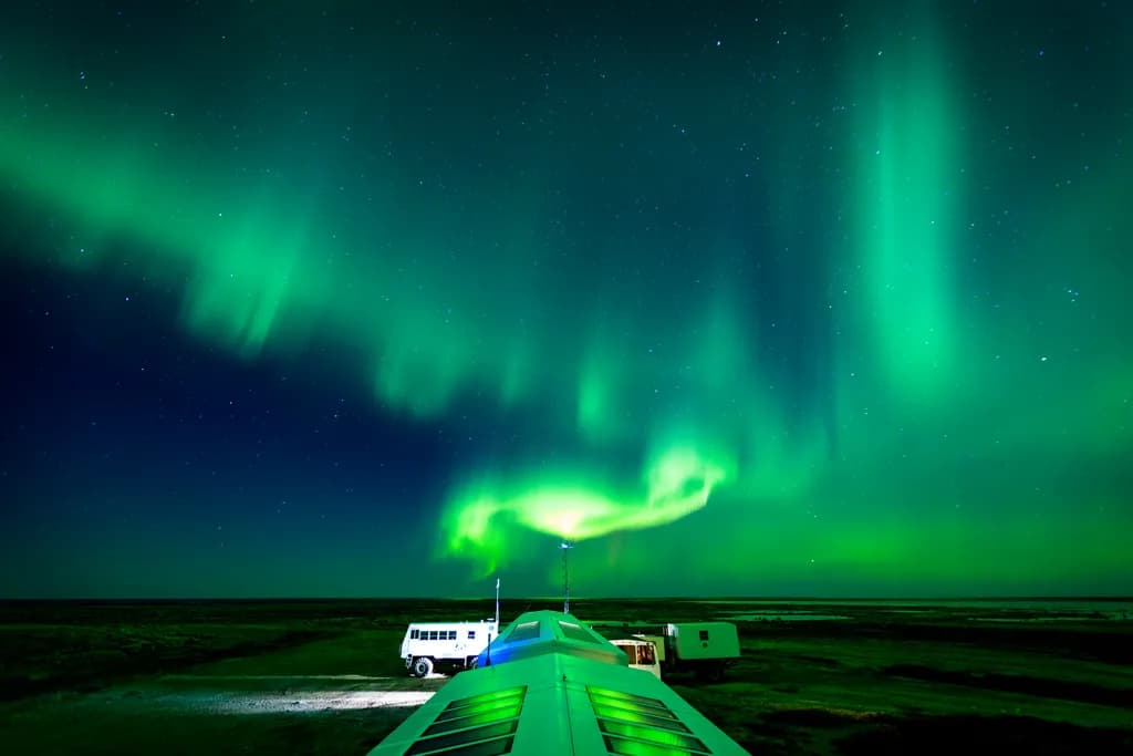 Whispers of the Aurora: A Night Sky Dance of Stars and Green Light