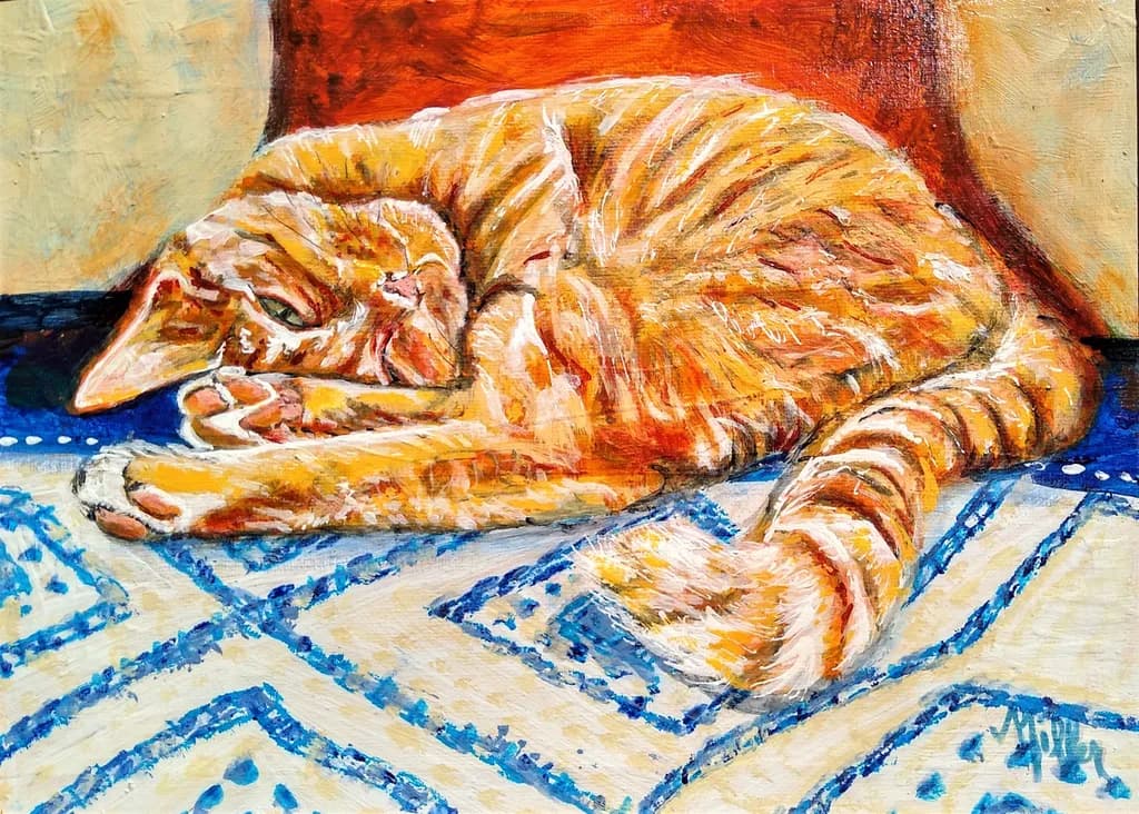 Whiskered Dreams: A Cozy Orange Cat Napping on a Blue Patterned Rug