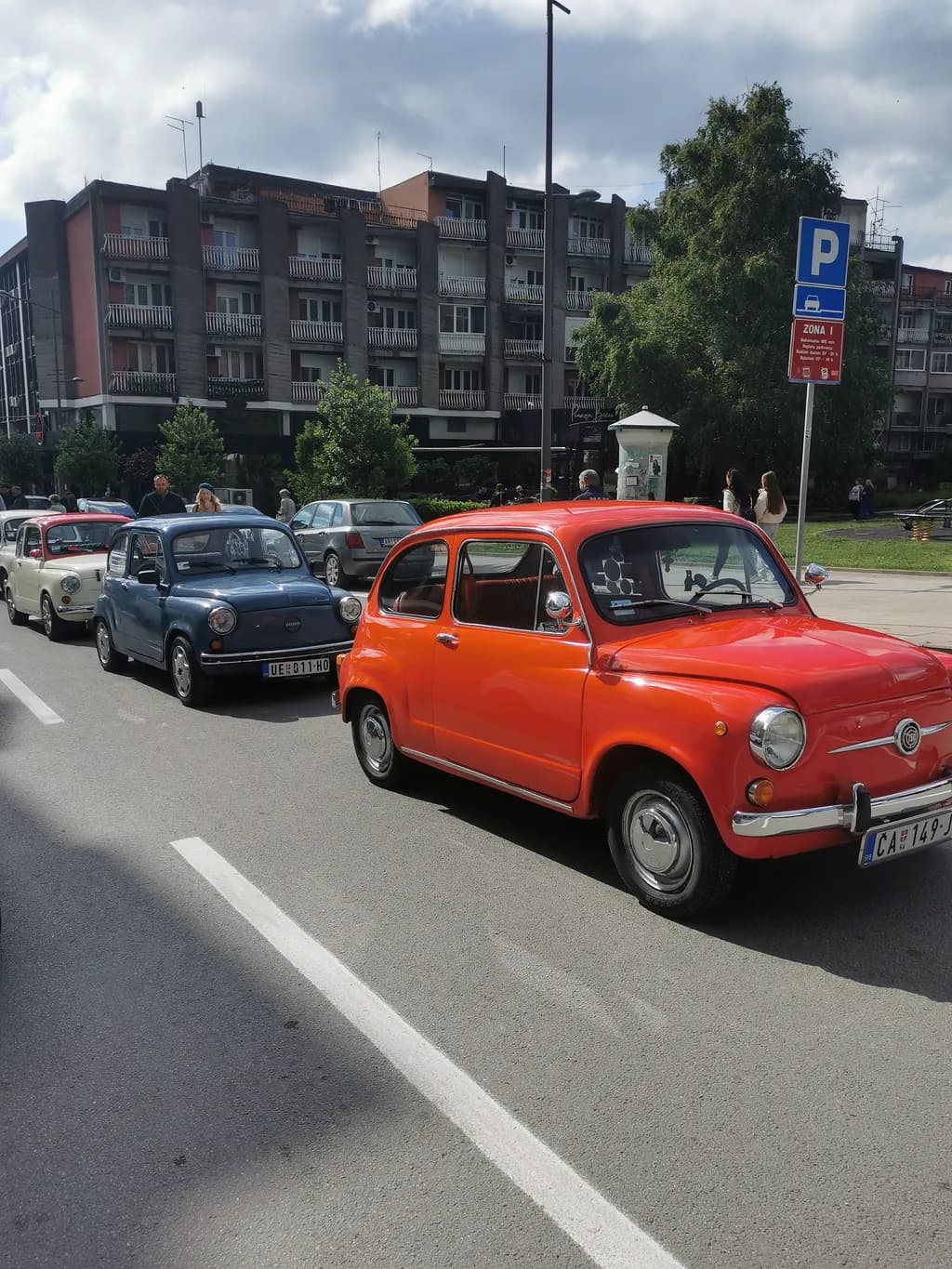 Vintage Urban Traffic: A Colorful Parade of Classic Cars in the Cityscape