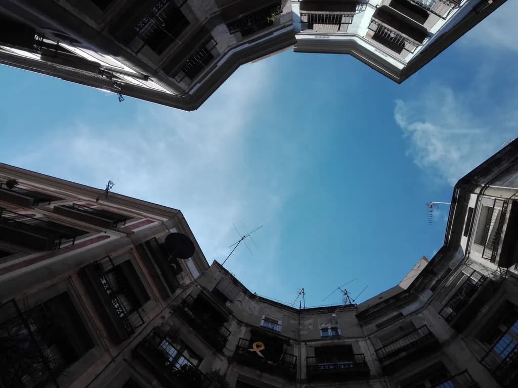 Urban Skyward: A Serene Glimpse into Architectural Angles and Urban Life