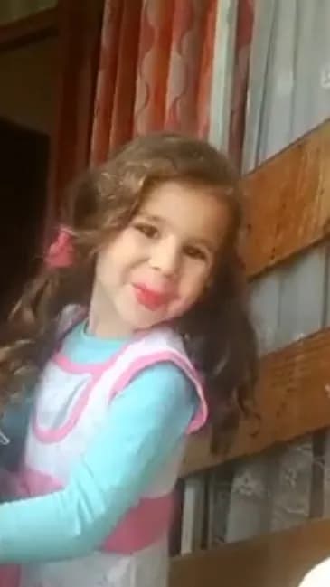 Joyful Innocence: A Playful Moment Captured in Curly Locks and Bright Smiles