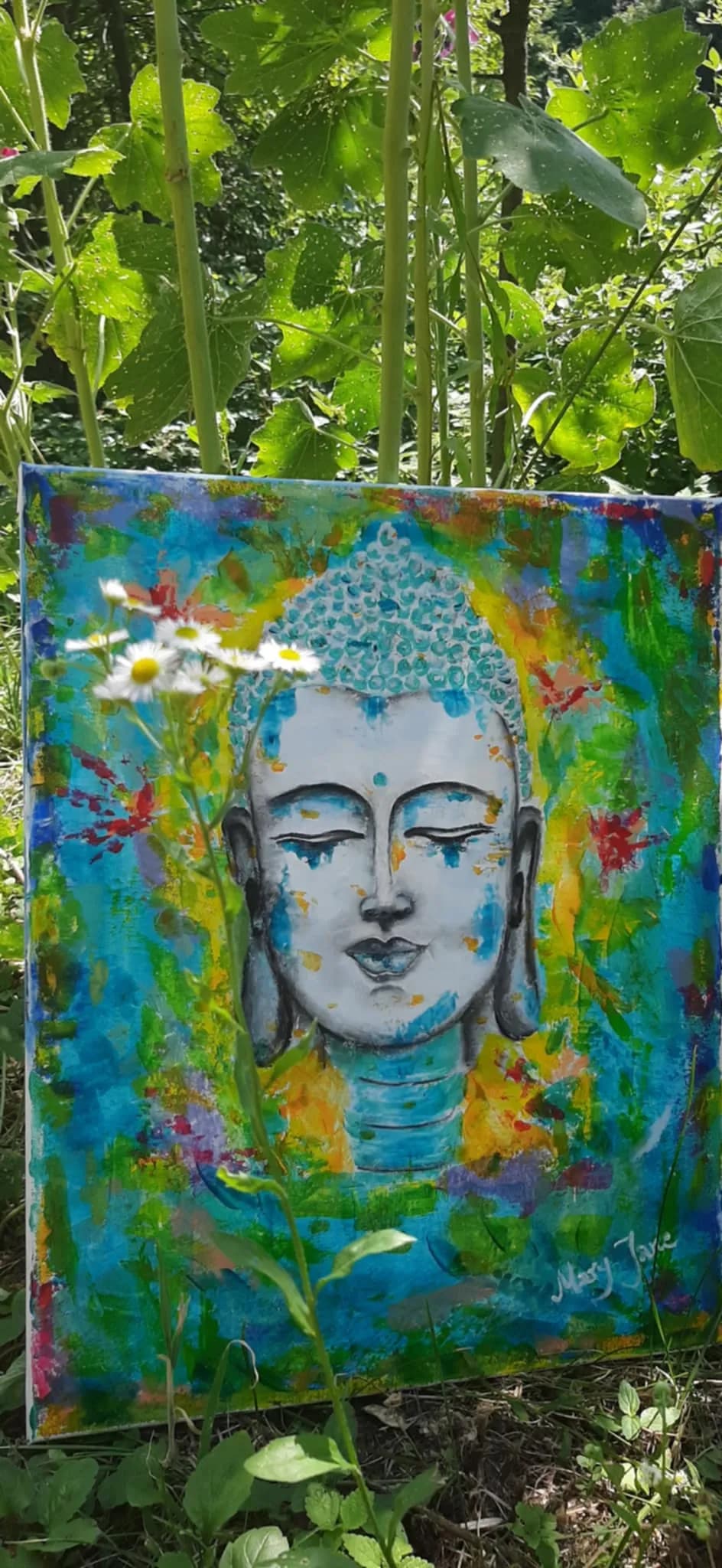 Serenity in Color: A Vibrant Buddha Expression Amidst Nature's Embrace