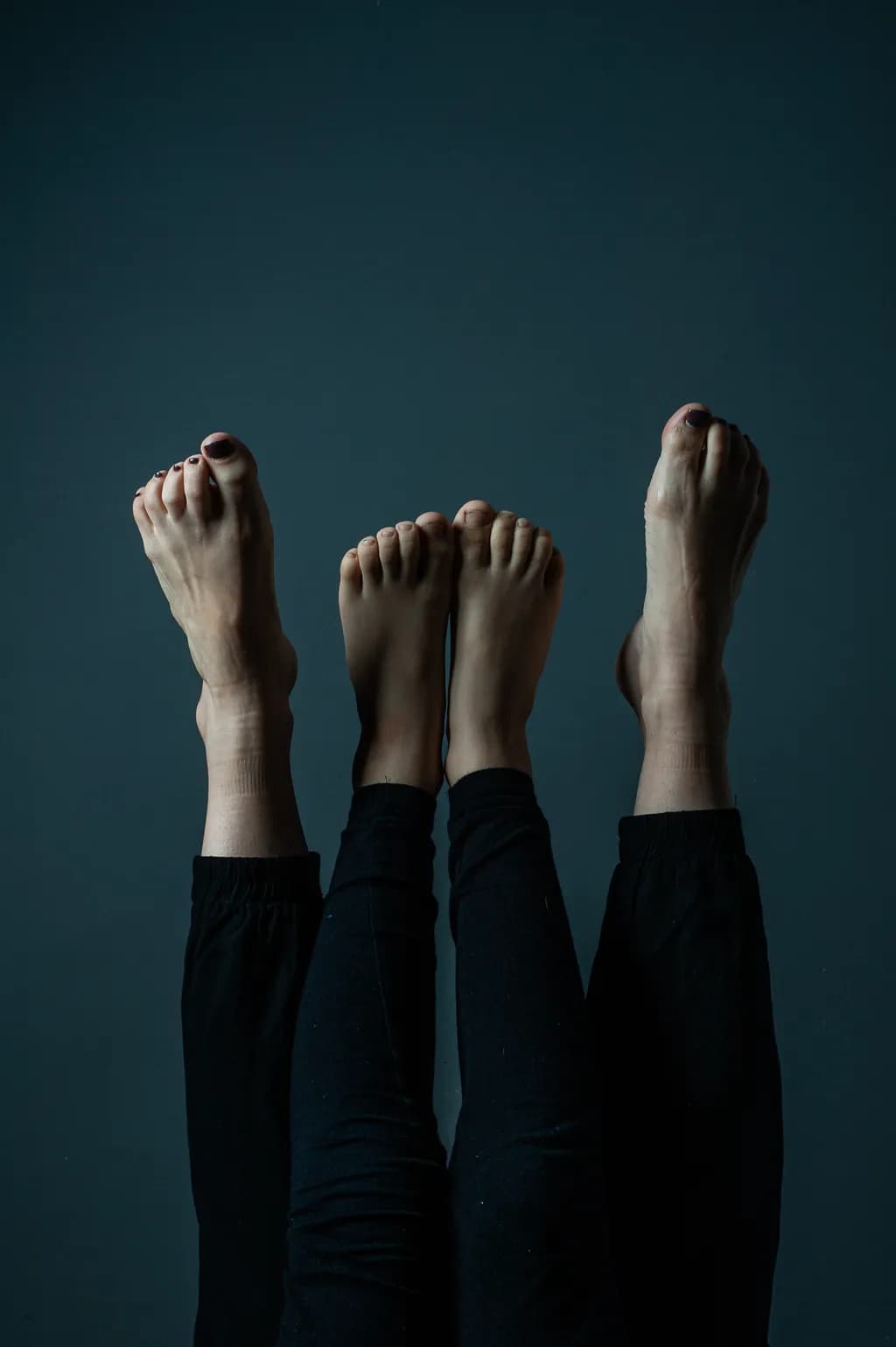 Ethereal Shadows: A Dance of Feet and Legs in Contrast