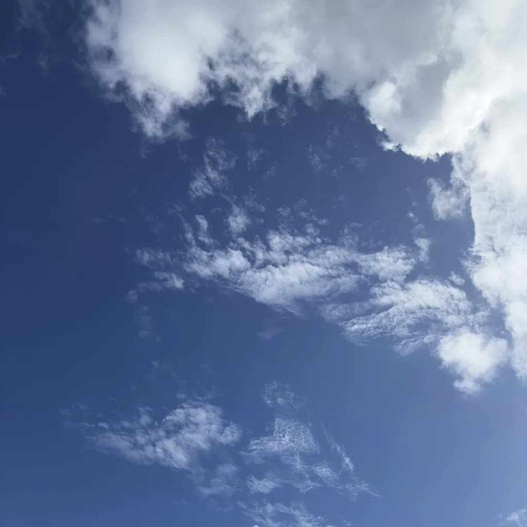Whispers of the Sky: A Serene Dance of Clouds and Blue