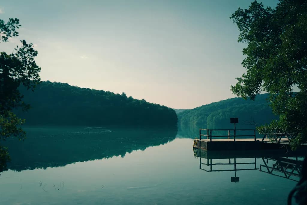 Serenity at Dawn: A Tranquil Lake Reflection in Nature's Embrace