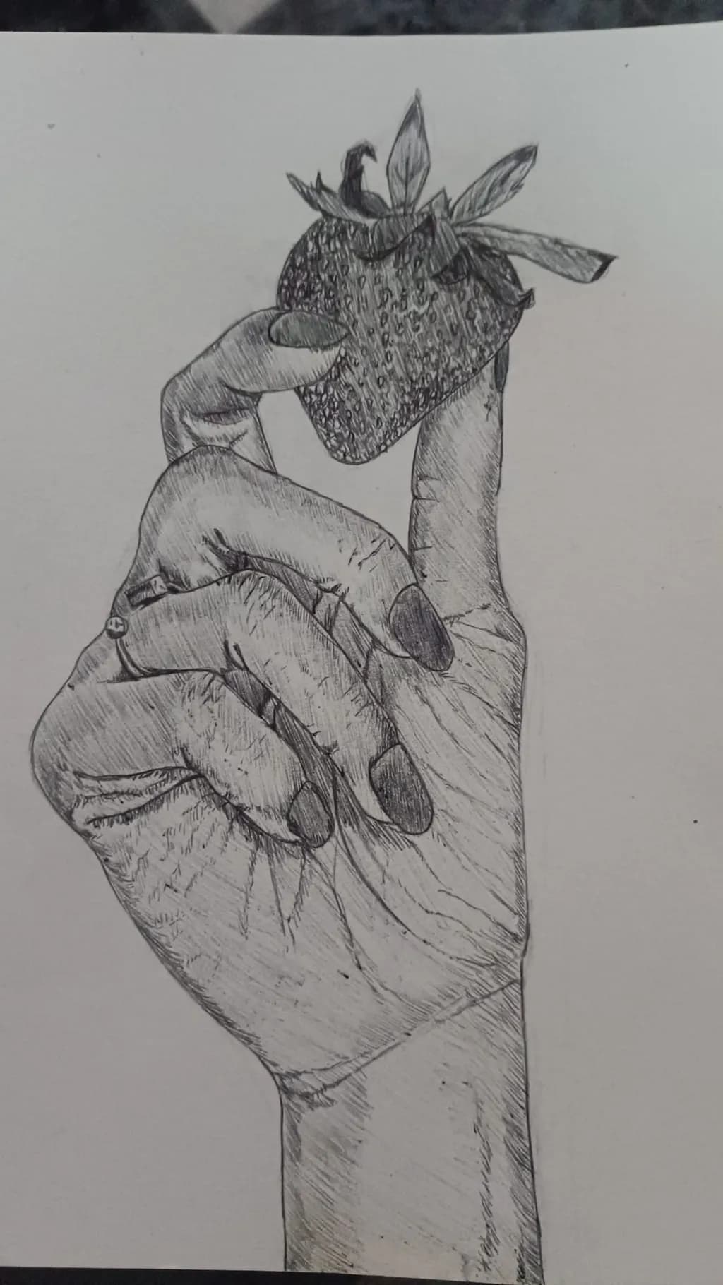 Delicate Gesture: A Hand Holding a Strawberry in Intricate Detail
