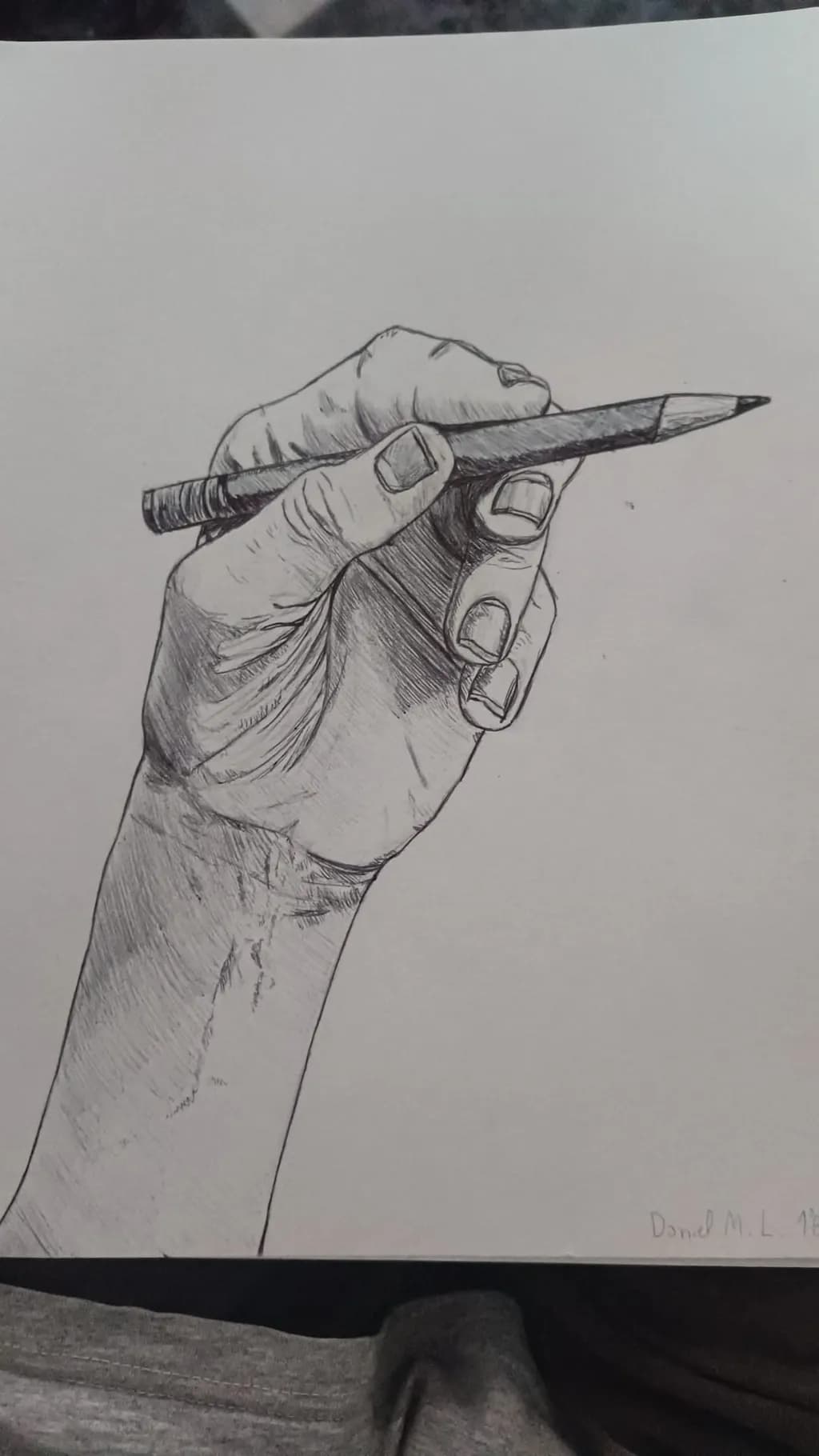 The Art of Creation: A Hand Grasping a Pencil in Intricate Detail