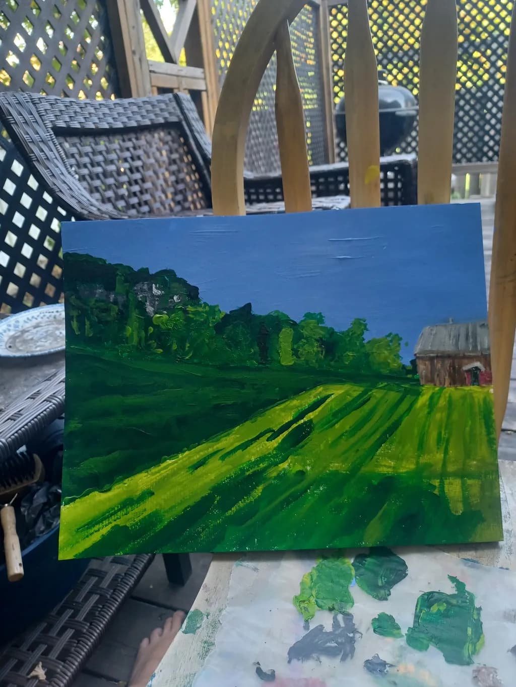 Serenity in Green: A Lush Landscape Painting of Rolling Fields and Tranquil Skies