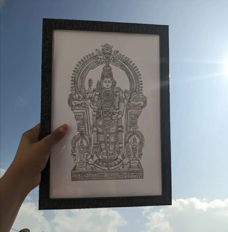 Divine Majesty: Intricate Framed Artwork of a Sacred Deity Against a Celestial Sky