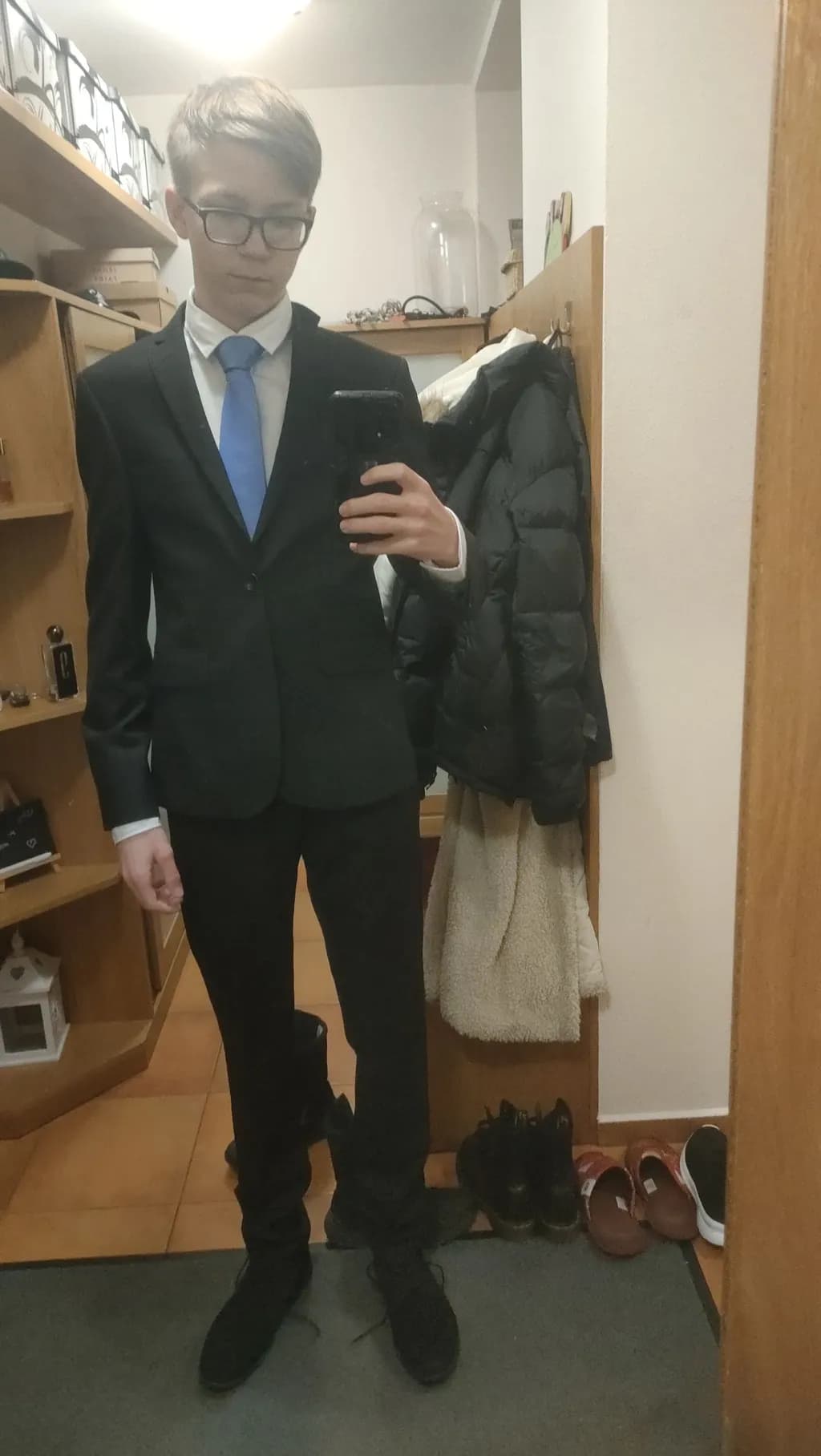 Dapper Reflections: A Young Man's Stylish Transformation in a Tailored Suit
