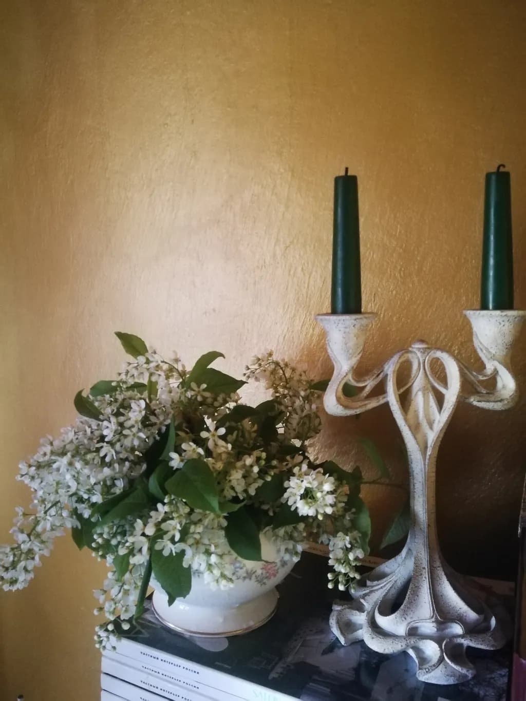 Whispers of Elegance: A Vintage Candleholder and Floral Harmony Against a Golden Backdrop