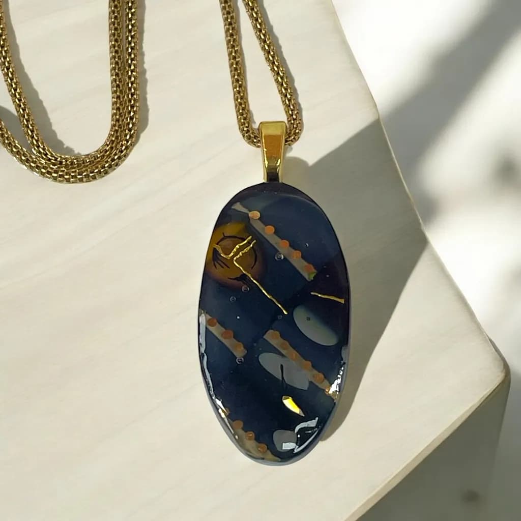 Celestial Harmony: Dichroic Glass Pendant with Golden Accents