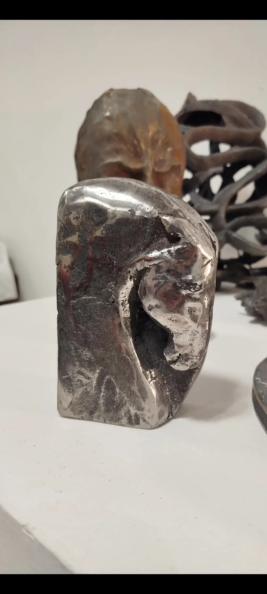 Whispers of Metal: Abstract Lion Sculpture in Polished Steel