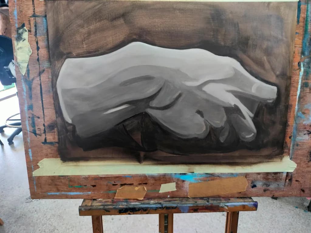 Gesture of Monochrome: A Hand in Artistry on Canvas
