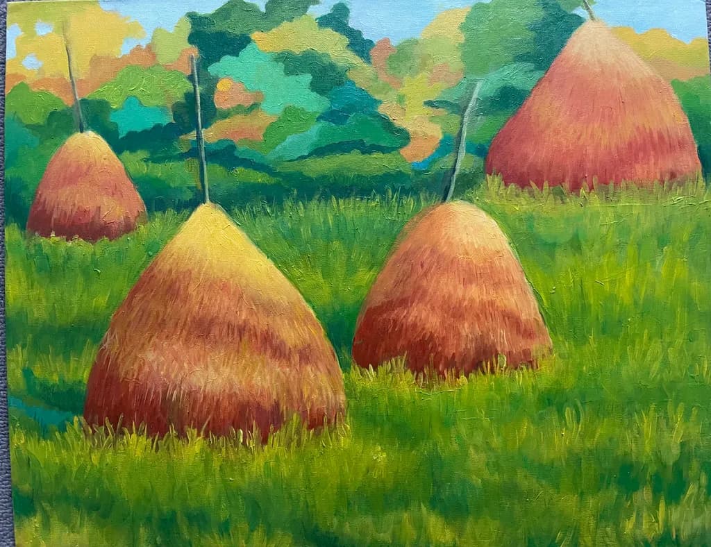 Golden Harvest: A Serene Landscape of Haystacks in Vibrant Green Fields