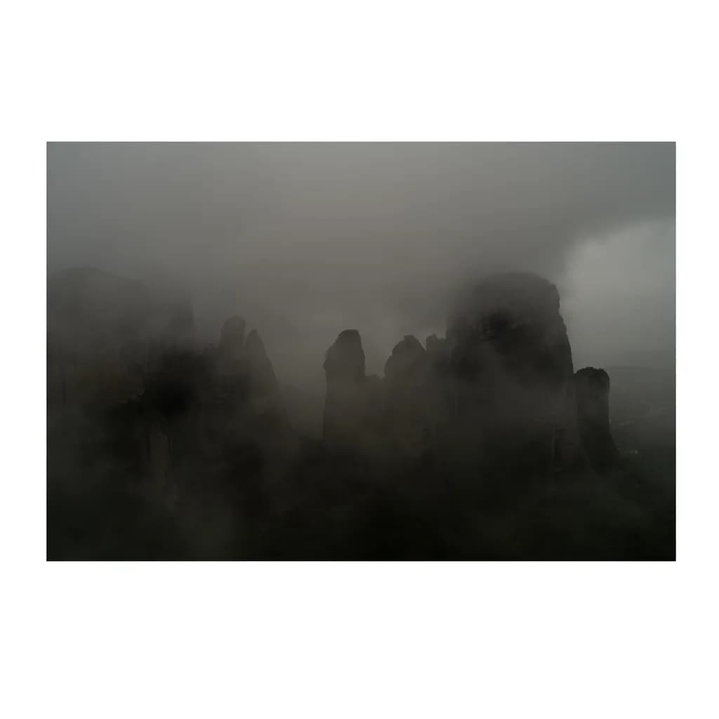 Whispers of the Mist: A Dramatic Rocky Landscape in Cloudy Embrace