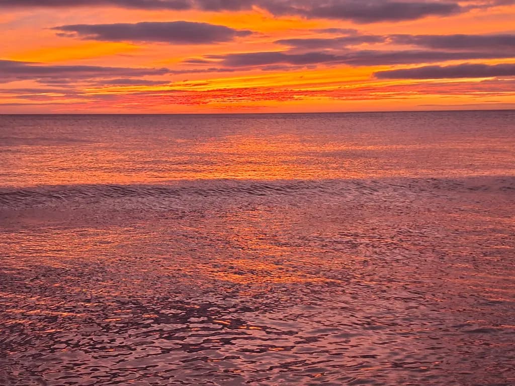 Serene Sunset Reflections: A Dance of Colors on Water