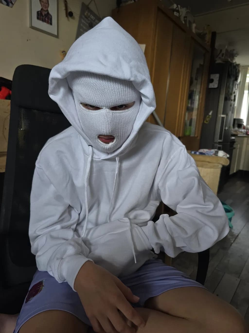 Masked Reflection: The Enigma of Youth in White Hoodie
