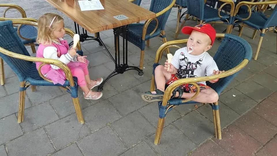 Joyful Moments: Children Indulging in Ice Cream Bliss at a Cozy Café
