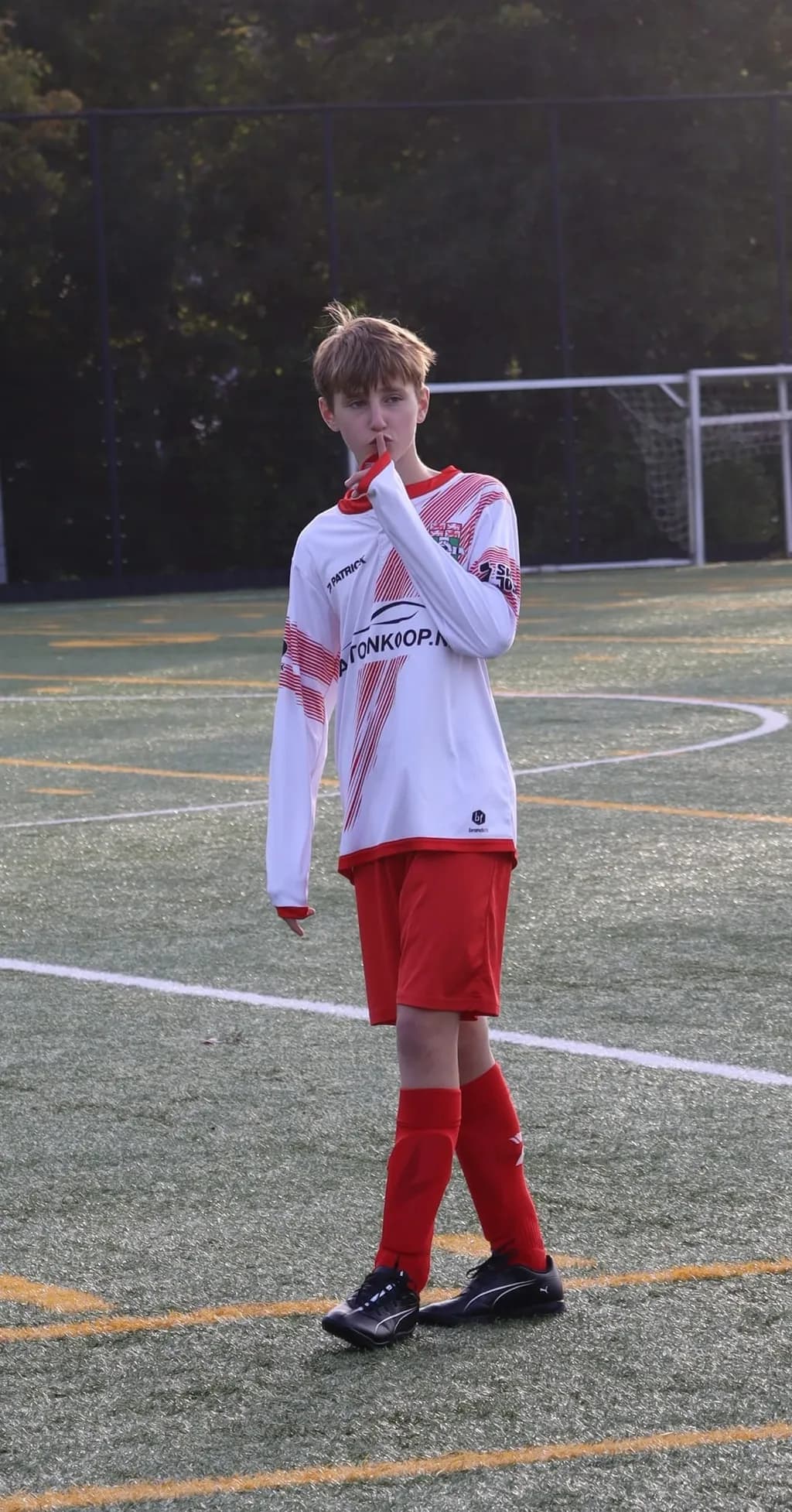 Silent Determination: A Young Athlete's Moment on the Field