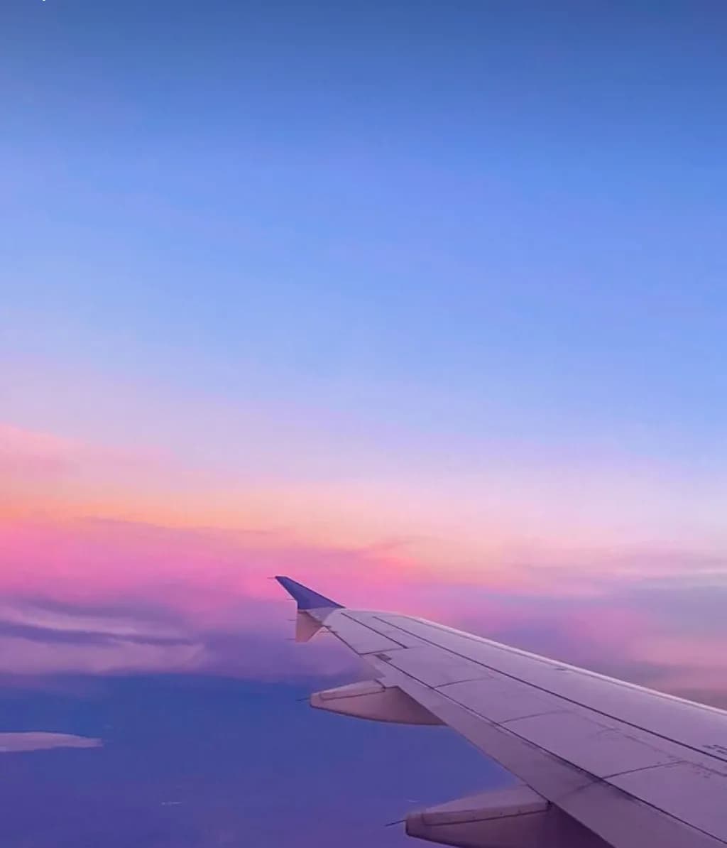 Wings of Wanderlust: A Serene Sunset Above the Clouds