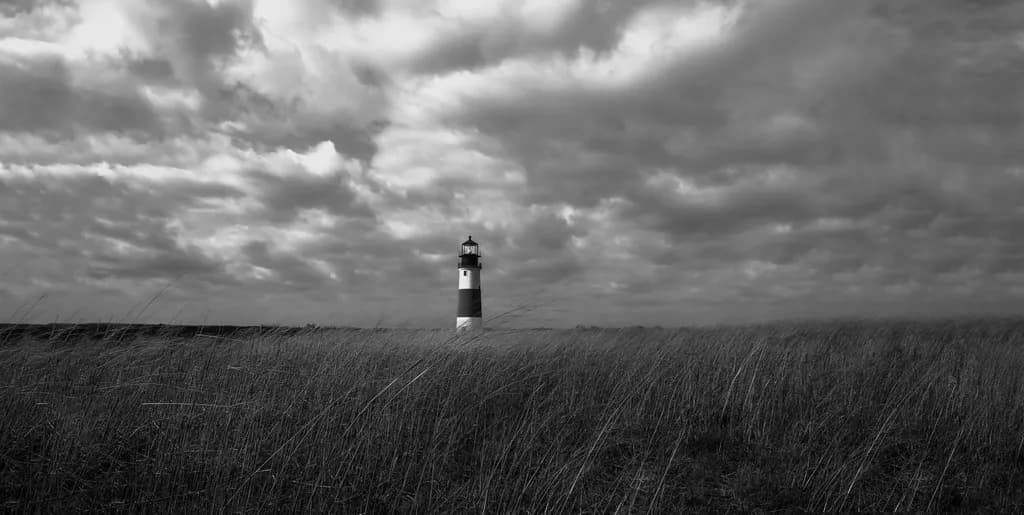 Whispers of the Lighthouse: A Monochrome Journey Through Stormy Skies