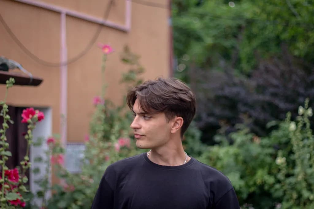 Whispers of Nature: A Contemplative Portrait of a Young Man Amidst Blossoms