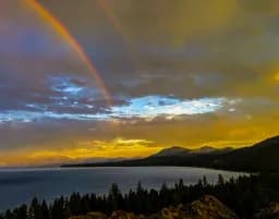 Rainbow Over Lake and Mountains