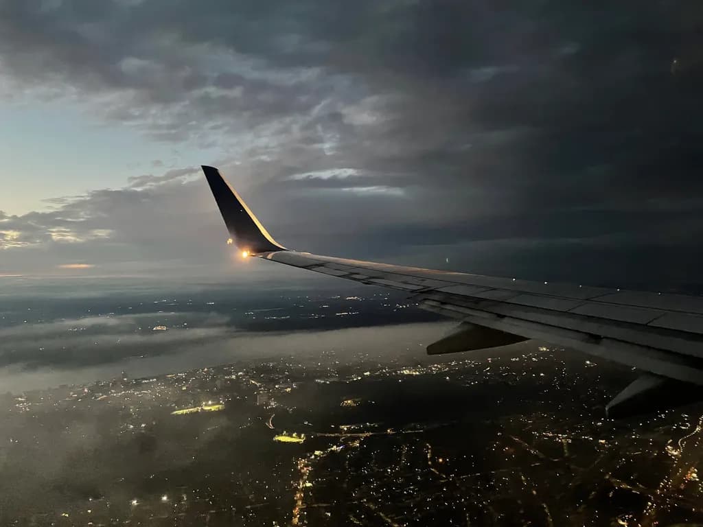 Night Flight Over City Lights