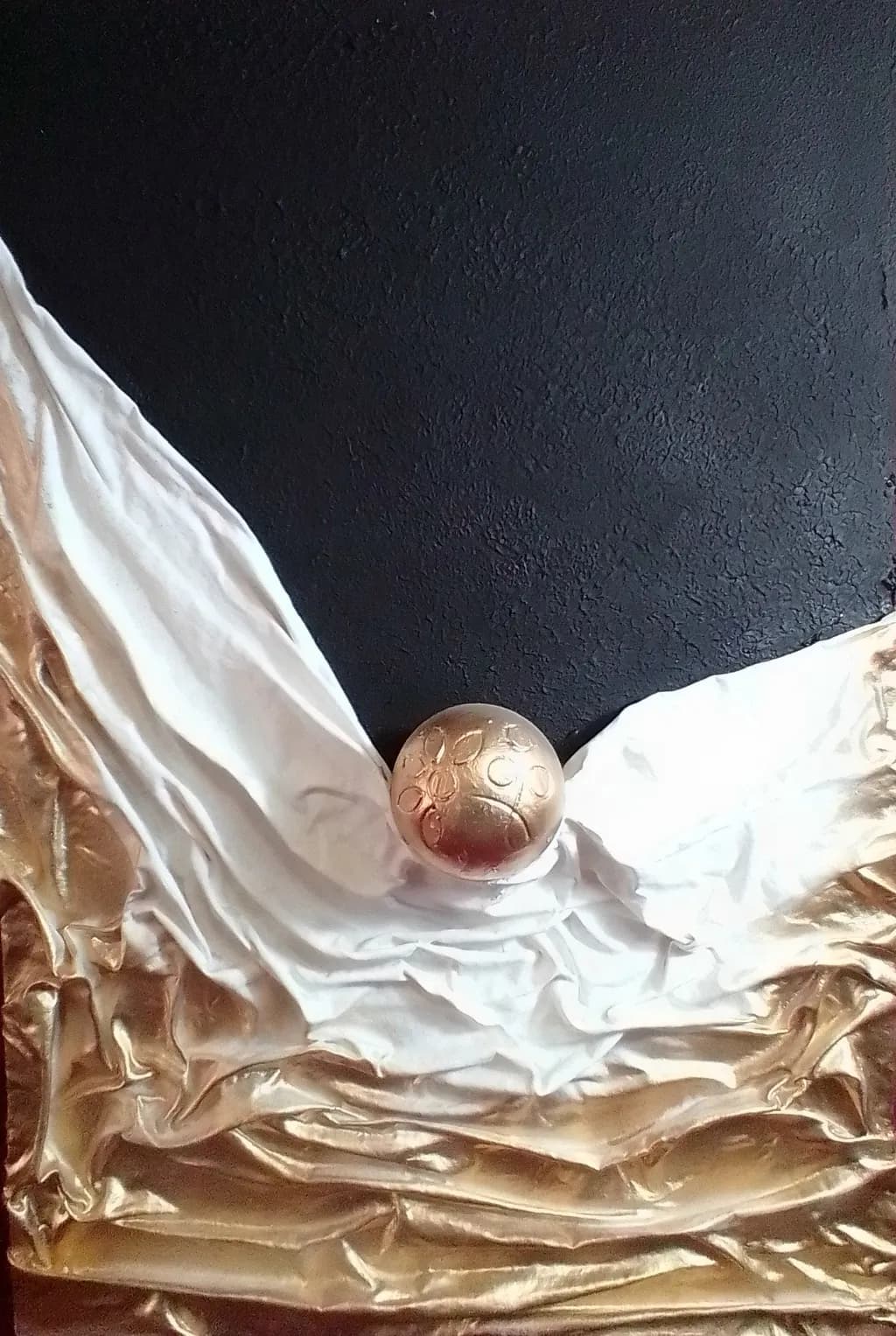 Golden Sphere on Draped Fabric