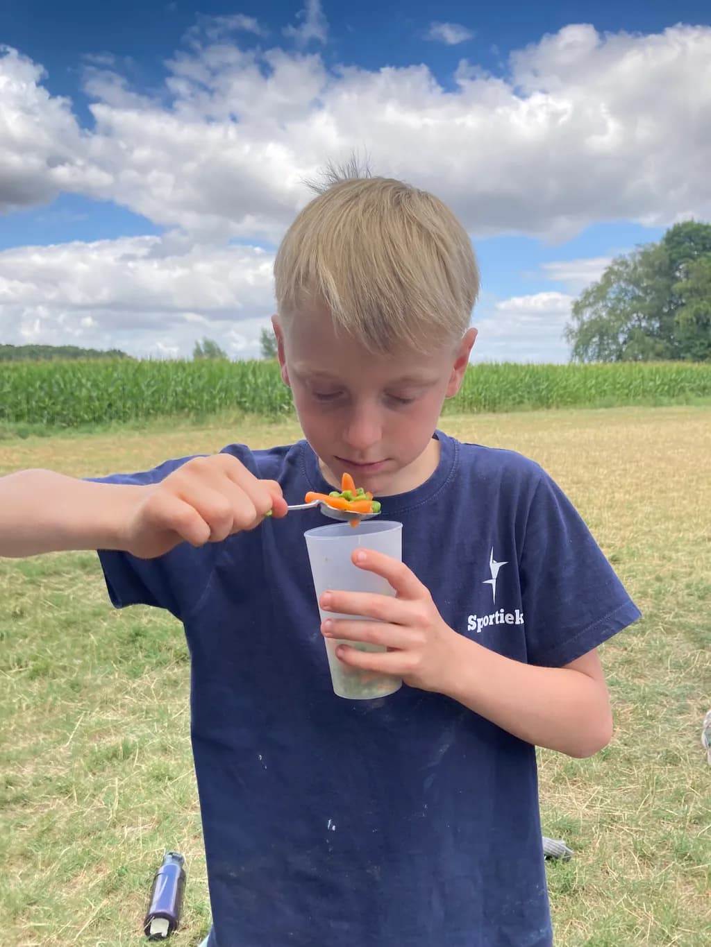 Boy with Cup in Field