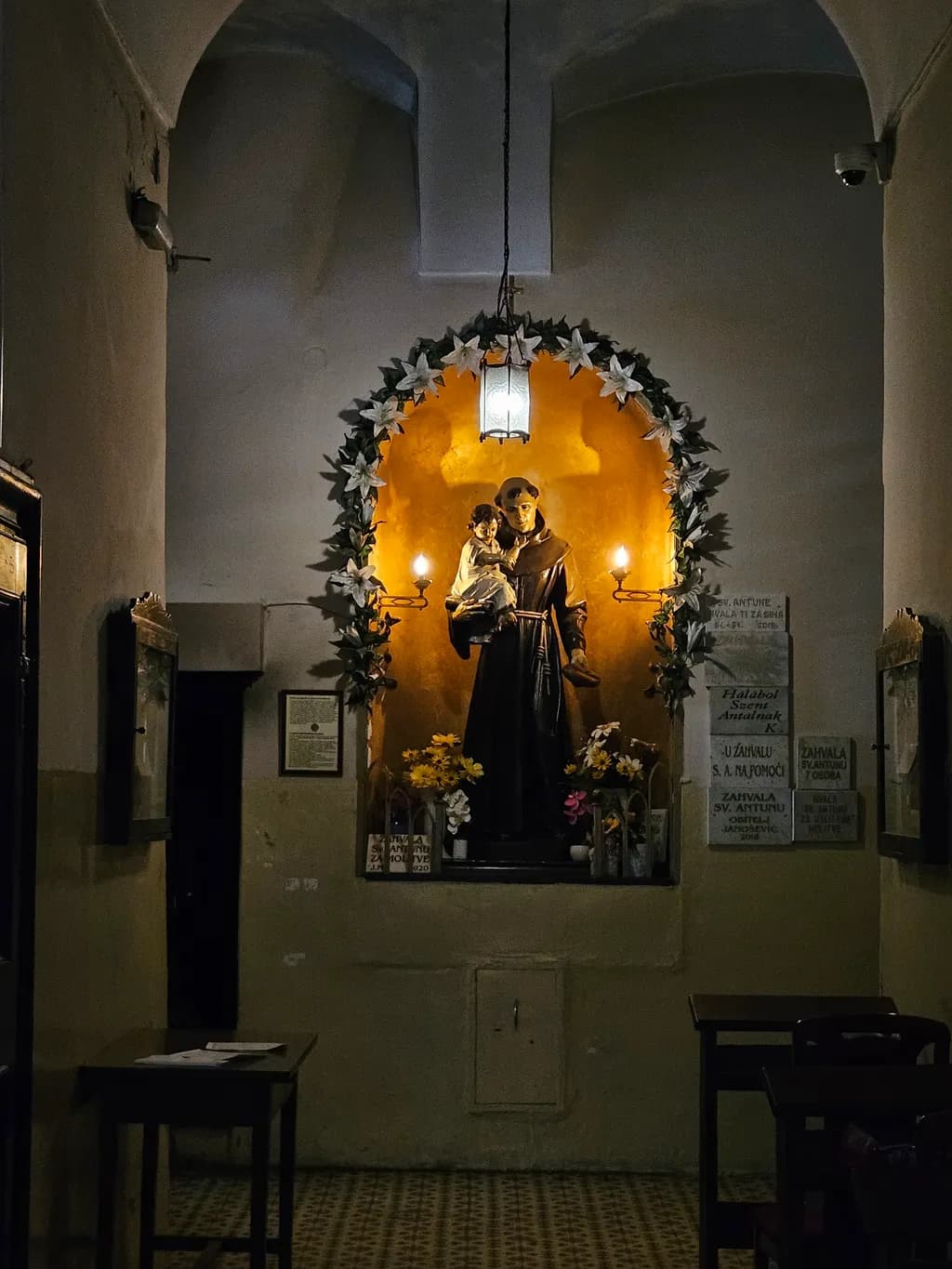 No specific subject nouns are present in the filename. Based on the image content, a fitting title would be:

Saint Statue Niche