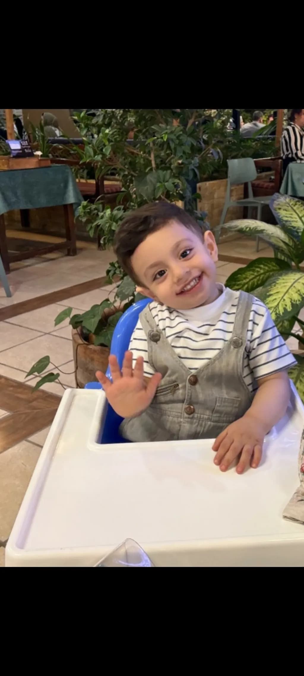 Smiling Toddler in Highchair