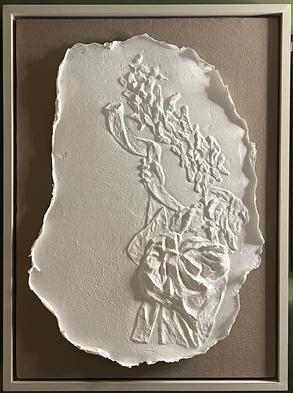 Ethereal Embrace: A Textured White Relief Sculpture Framed in Serenity