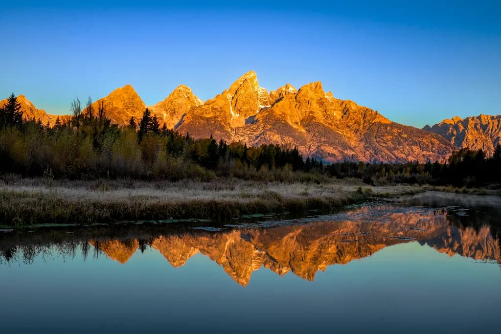 Majestic Reflections: The Golden Peaks of Grand Teton at Dawn