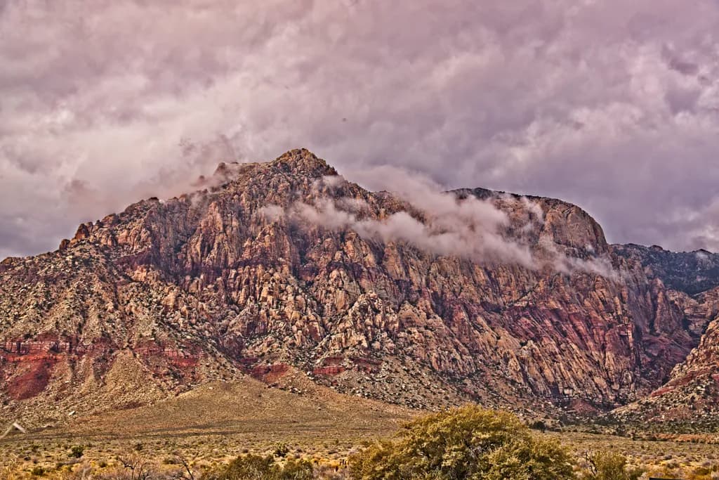 Majestic Mountains: A Dramatic Dance of Clouds and Rock Formations in Nature's Canvas