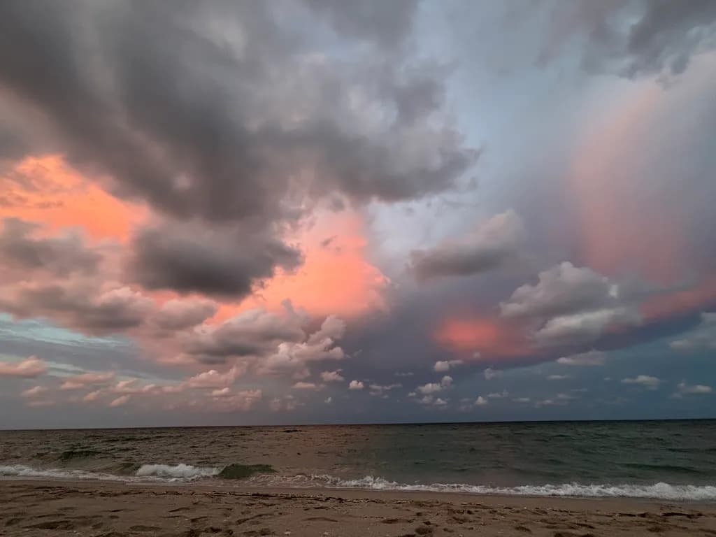 Serenity at Sunset: A Tranquil Beachscape Under Colorful Clouds