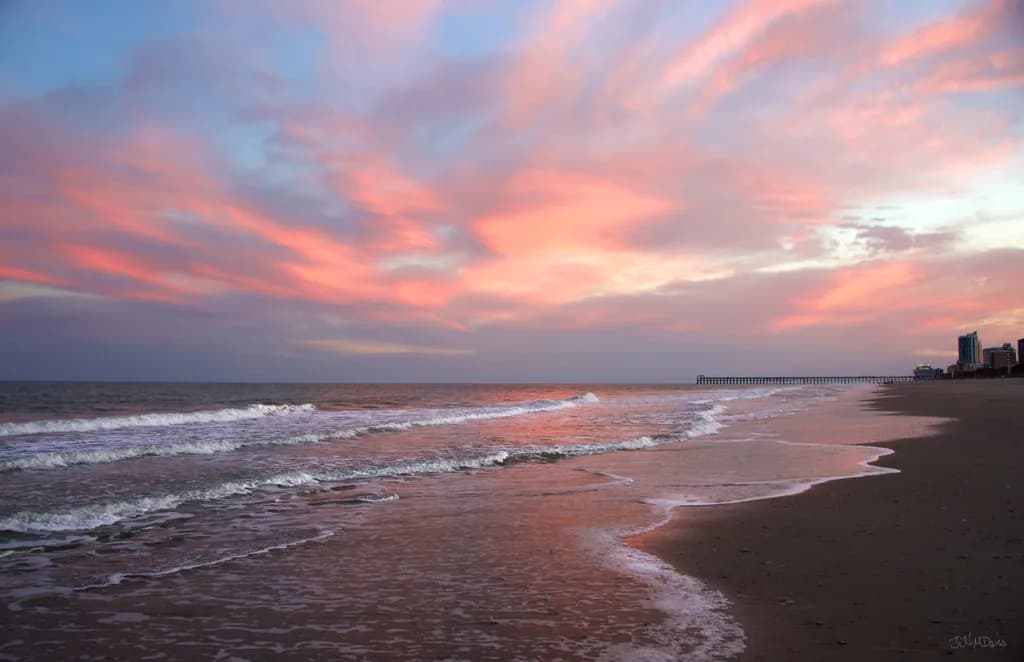 Serenity at Dusk: A Tranquil Beach Sunset Over Gentle Waves