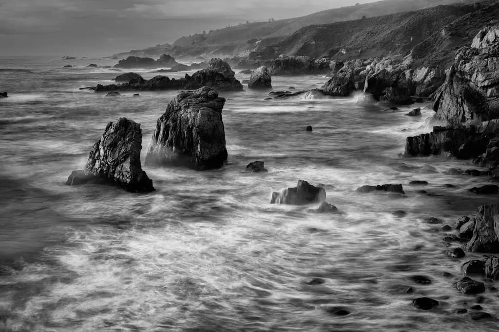 Whispers of the Ocean: A Monochrome Dance of Rocks and Waves