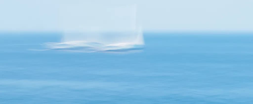 Whispers of the Ocean: A Blurred Journey with Sailboats in Blue Serenity